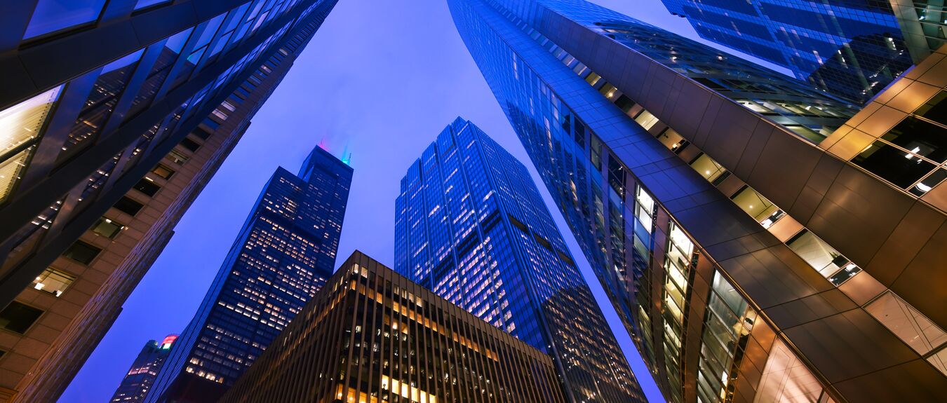 Looking up at Chicago's skyscrapers in financial district at dusk